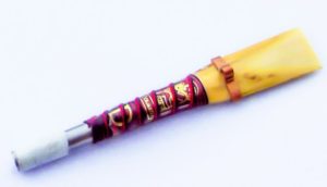 Handmade uilleann pipe reed made by Brian Howard. Stainless steel staple, red binding