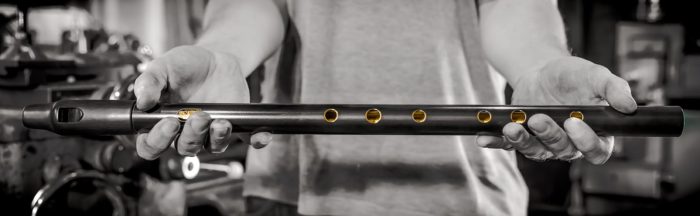 Best low D whislte, a black and gold special finish Howard held and presented against a backdrop of the whistle making workshop in Sheffield.